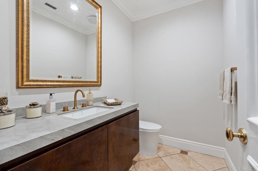 6773 Poco Lago Rancho Santa Fe, CA 92067 - Photo 26 of 65 a bathroom with a sink a toilet and mirror