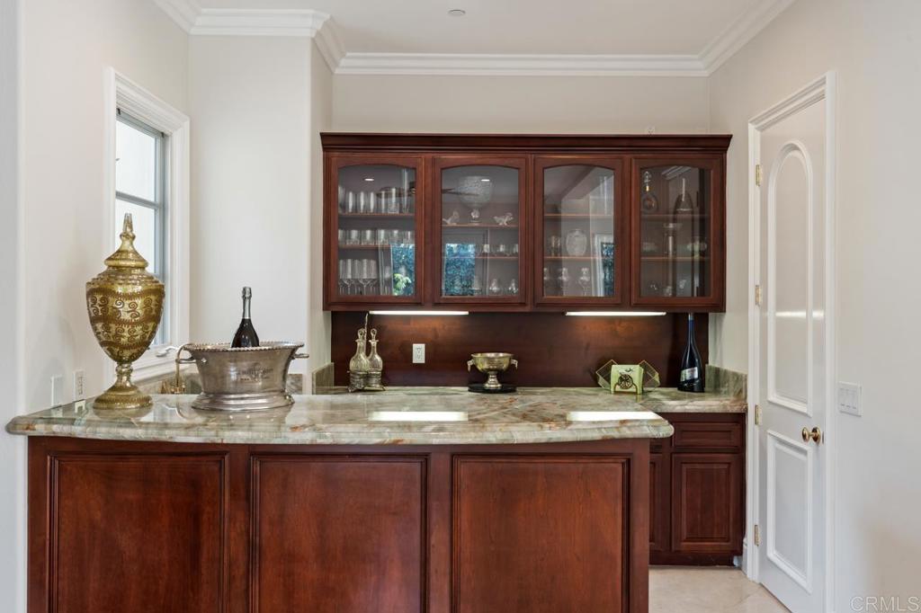 6773 Poco Lago Rancho Santa Fe, CA 92067 - Photo 32 of 65 a bathroom with a granite countertop sink and a mirror