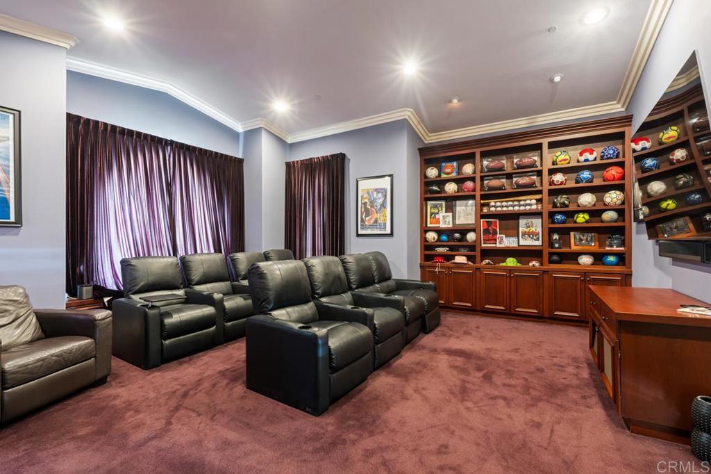 6773 Poco Lago Rancho Santa Fe, CA 92067 - Photo 33 of 65 a living room with furniture window and bookshelf