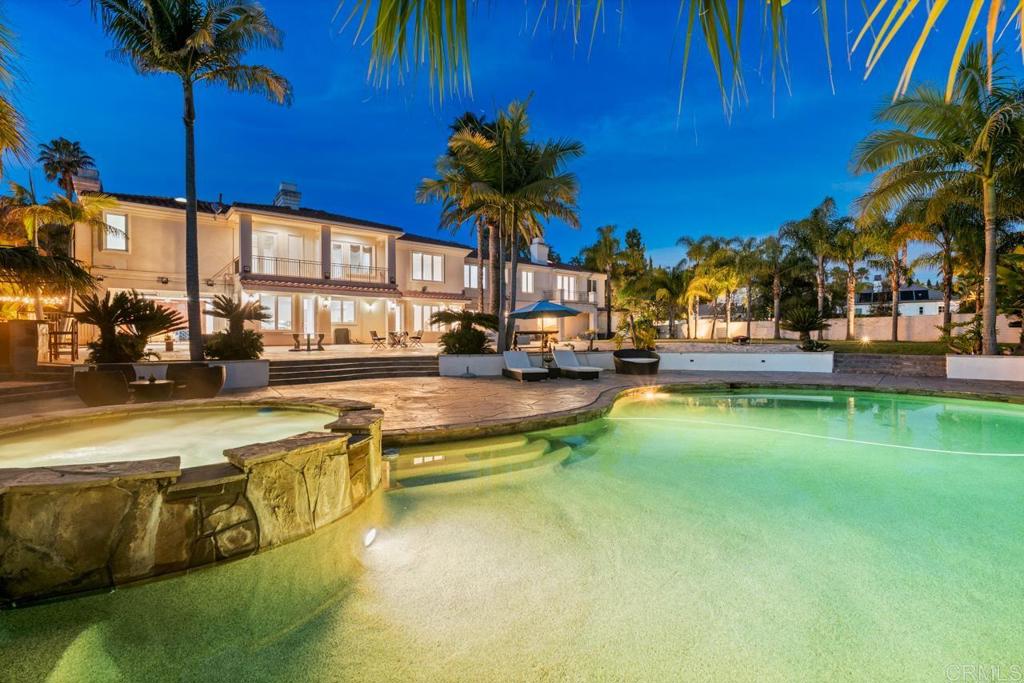 6773 Poco Lago Rancho Santa Fe, CA 92067 - Photo 51 of 65 a view of a swimming pool with lawn chairs under an umbrella