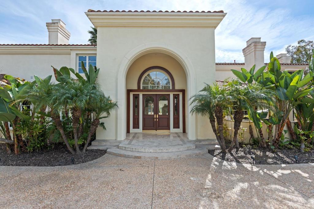 6773 Poco Lago Rancho Santa Fe, CA 92067 - Photo 9 of 65 a front view of a house with garden