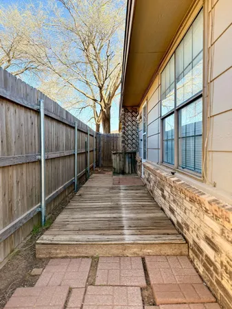 a view of a backyard with large trees