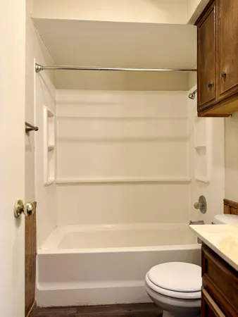 a bathroom with a toilet and a bathtub