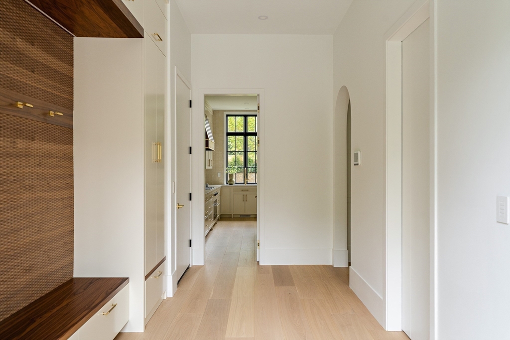 19 Bonnybrook Road Newton, MA 02468 - Photo 17 of 42 a view of a hallway with wooden floor and a living room