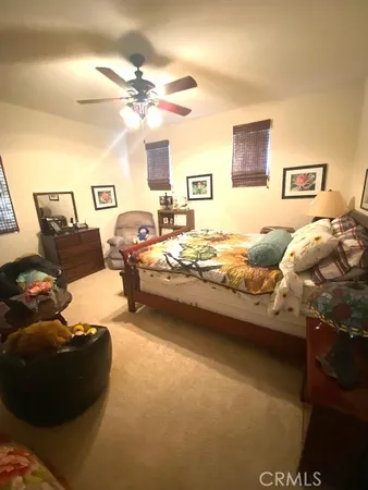 a room with lots of white furniture and a large window