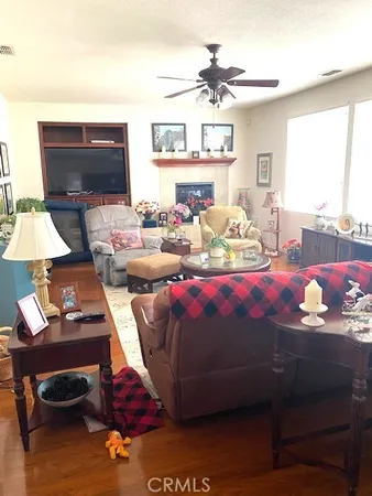 a bedroom with furniture and a flat screen tv