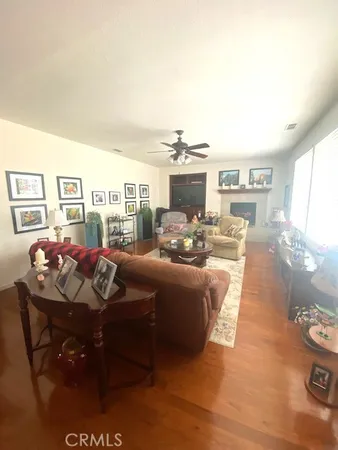 a living room with furniture and a kitchen