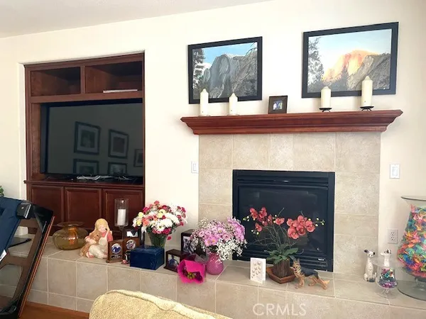 a kitchen with a dining table chairs and refrigerator