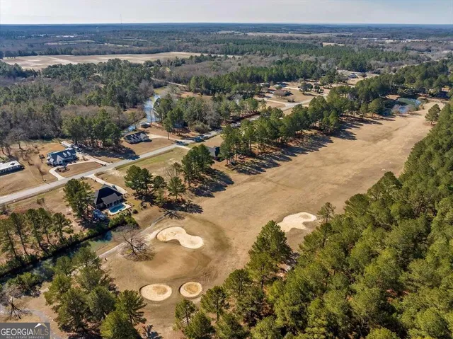 an aerial view of a house with outdoor space and lake view