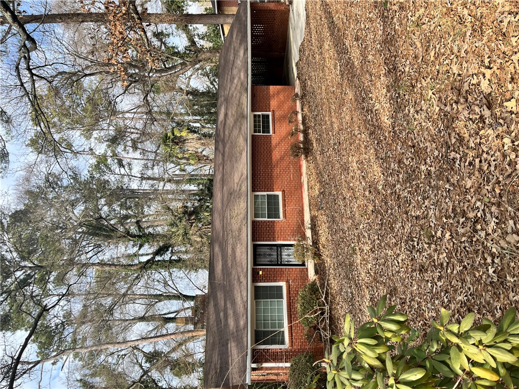 207 Pine Lane Anderson, SC 29621 - Photo 1 of 13 This classic brick residence presents a welcoming facade amidst natural surroundings.