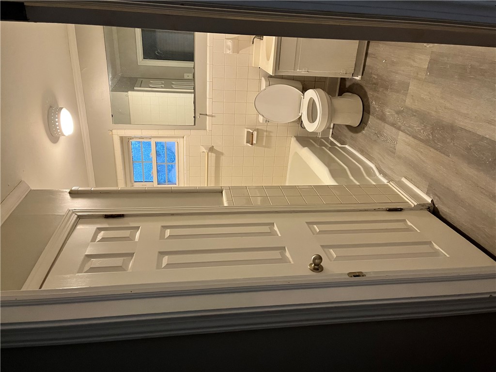 207 Pine Lane Anderson, SC 29621 - Photo 5 of 13 This bright bathroom features a classic tub and modern flooring, offering comfort and style.