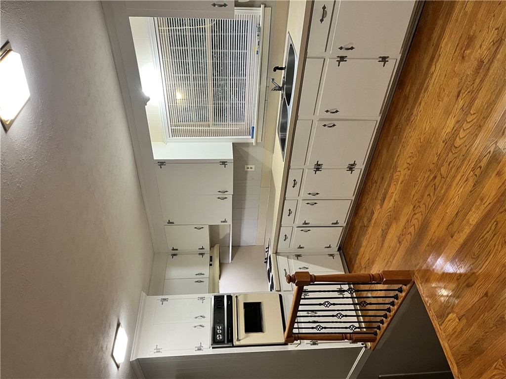 207 Pine Lane Anderson, SC 29621 - Photo 6 of 13 This spacious kitchen offers ample cabinetry and polished wood flooring.