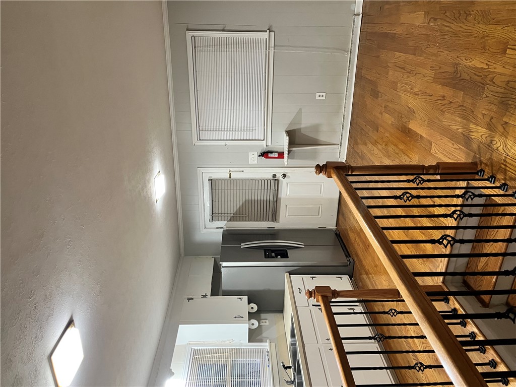 207 Pine Lane Anderson, SC 29621 - Photo 7 of 13 This interior offers a functional kitchen with seamless access to a well-crafted staircase.