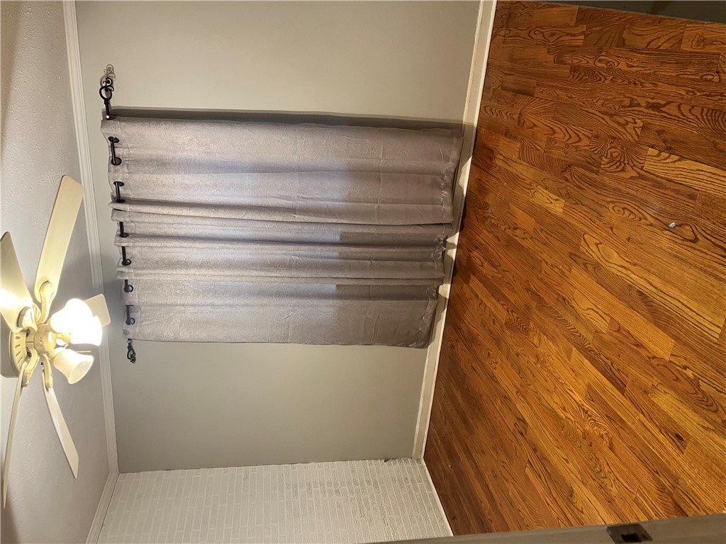 207 Pine Lane Anderson, SC 29621 - Photo 9 of 13 This interior features rich wood flooring, elegant window treatments, and a ceiling fan.