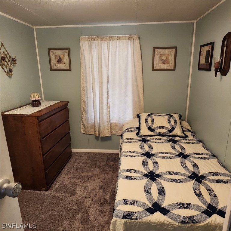 302 Pinecrest Avenue Moore Haven, FL 33471 - Photo 15 of 17 a bedroom with a bed and a window