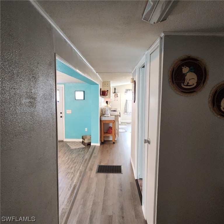 302 Pinecrest Avenue Moore Haven, FL 33471 - Photo 17 of 17 a view of a hallway view of a house with wooden floor windows and entryway
