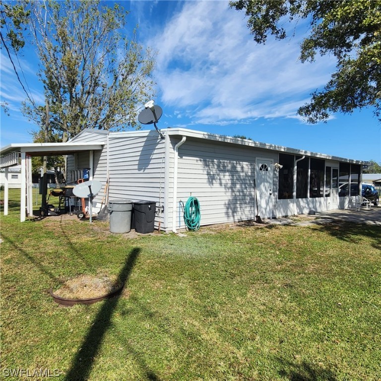 302 Pinecrest Avenue Moore Haven, FL 33471 - Photo 7 of 17 a view of a house with backyard and sitting area