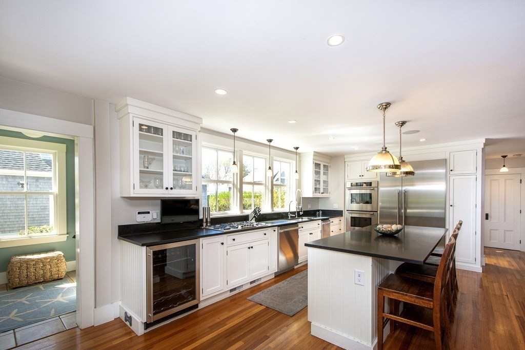 17 Gannett Road Scituate, MA 02066 - Photo 11 of 36 a kitchen with granite countertop a sink stove and cabinets