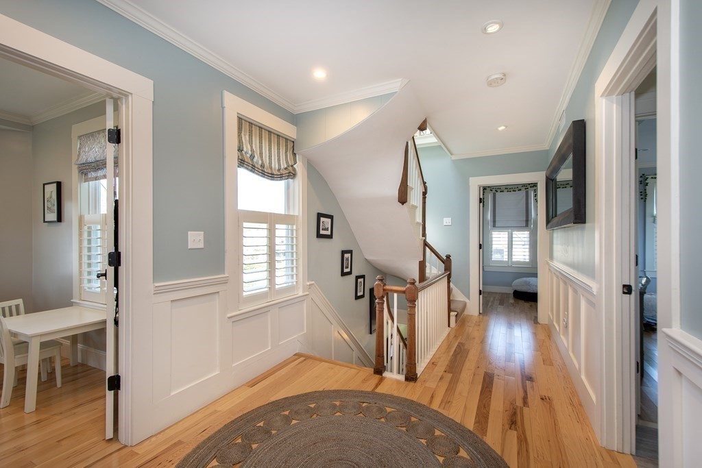 17 Gannett Road Scituate, MA 02066 - Photo 26 of 36 a view of a livingroom with wooden floor and stairs