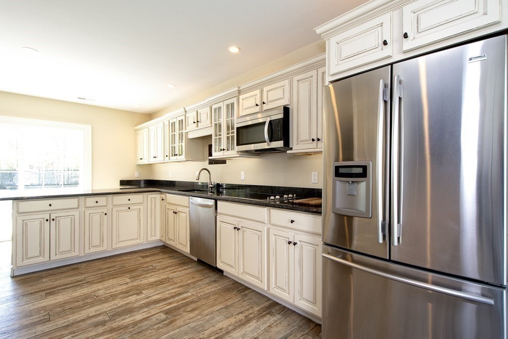 17 Gannett Road Scituate, MA 02066 - Photo 31 of 36 a kitchen with stainless steel appliances a refrigerator sink and microwave