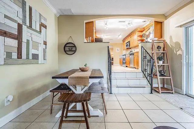 a living room with furniture and a book shelf