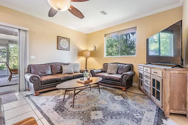 a bedroom with a bed and painting on the wall