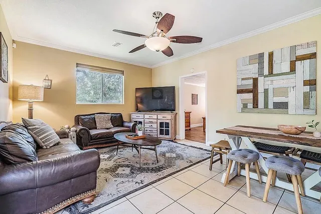 a kitchen with stainless steel appliances a refrigerator a stove and white cabinets