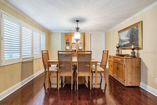 a view of a dining room with furniture wooden floor and chandelier