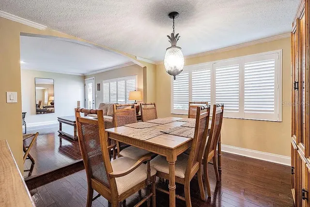 a kitchen with granite countertop a refrigerator and a stove top oven