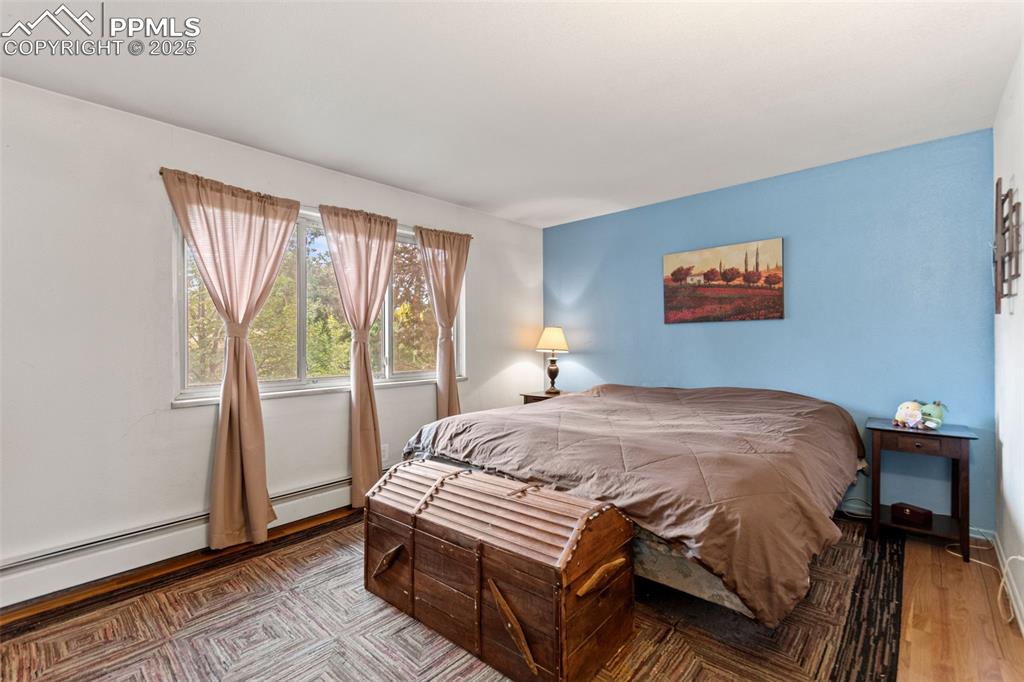 2801 South Reed Street Denver, CO 80227 - Photo 21 of 44 a bed sitting in a bedroom next to a window