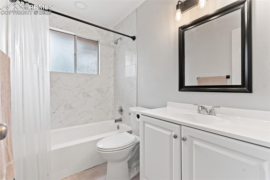 2801 South Reed Street Denver, CO 80227 - Photo 23 of 44 a bathroom with a toilet a sink and a bathtub