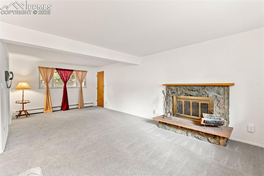 2801 South Reed Street Denver, CO 80227 - Photo 27 of 44 a living room with a fireplace furniture and a large window