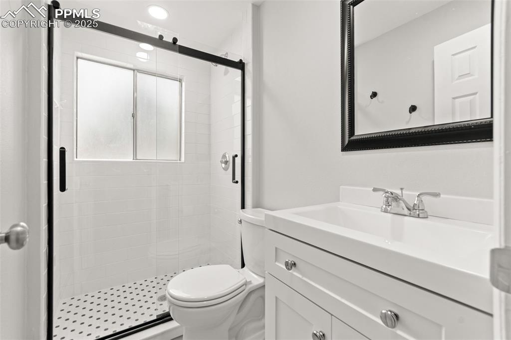 2801 South Reed Street Denver, CO 80227 - Photo 32 of 44 a bathroom with a sink toilet and shower