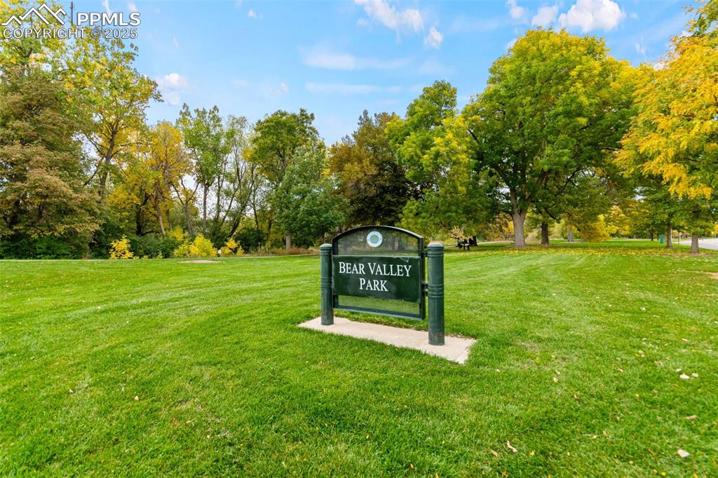 2801 South Reed Street Denver, CO 80227 - Photo 40 of 44 a sign that is sitting in the grass near a tree