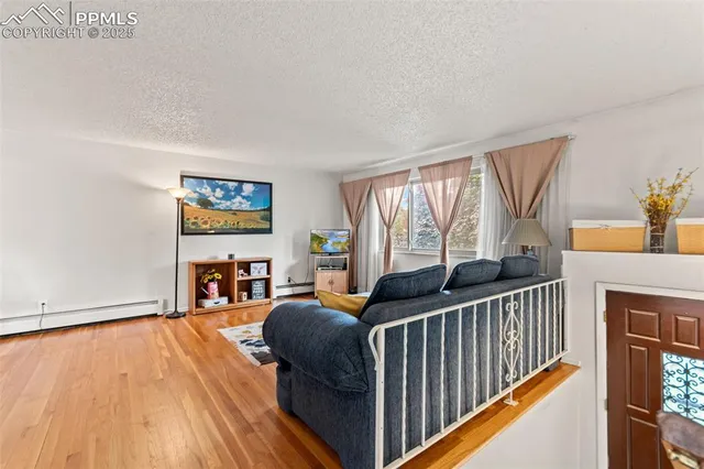 a living room with furniture and a floor to ceiling window