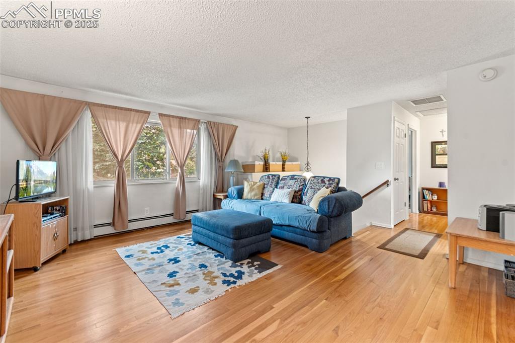 2801 South Reed Street Denver, CO 80227 - Photo 8 of 44 a living room with furniture and a flat screen tv