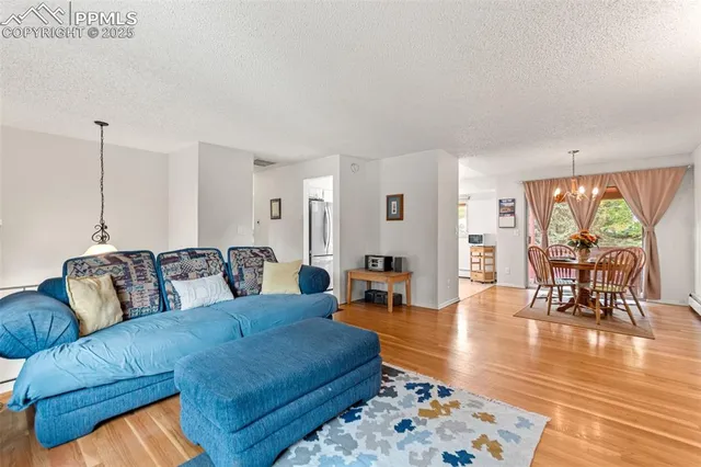 a living room with furniture wooden floor and a table