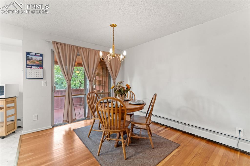 2801 South Reed Street Denver, CO 80227 - Photo 10 of 44 a view of a dining room with furniture window and wooden floor