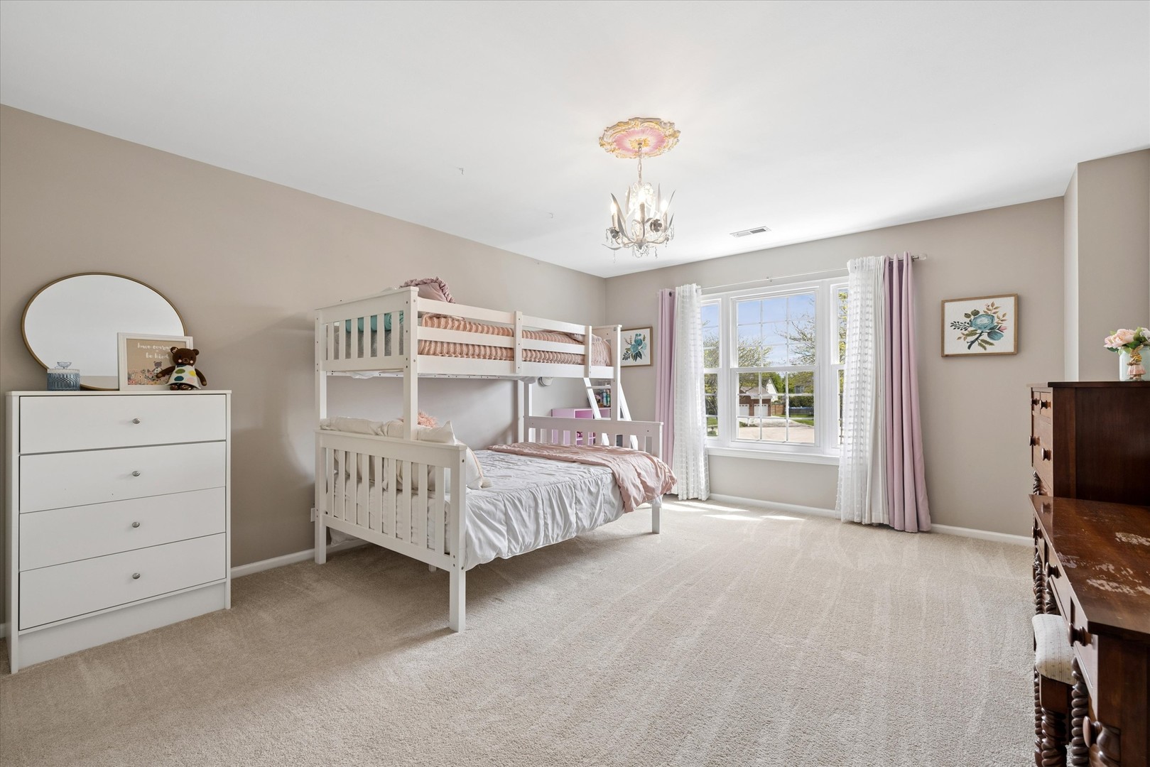 340 Tenby Way Algonquin, IL 60102 - Photo 20 of 36 a bedroom with a bed and a chandelier