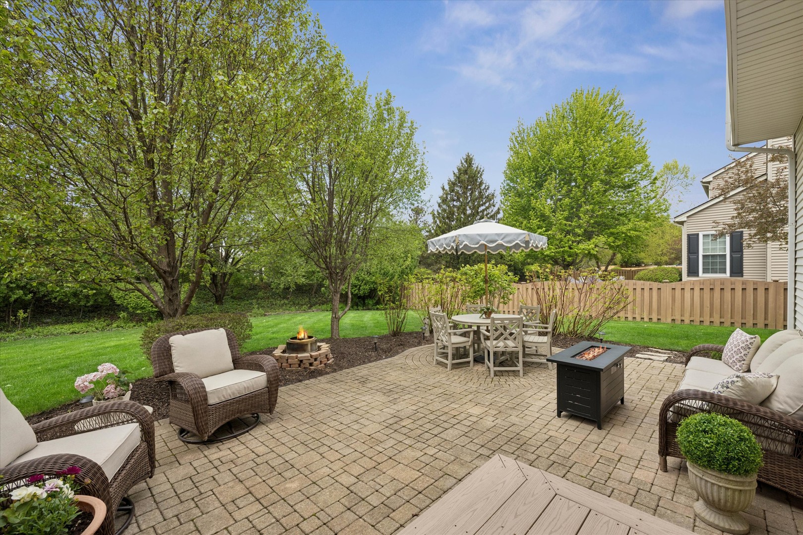 340 Tenby Way Algonquin, IL 60102 - Photo 30 of 36 a view of a patio with couches table and chairs and potted plants