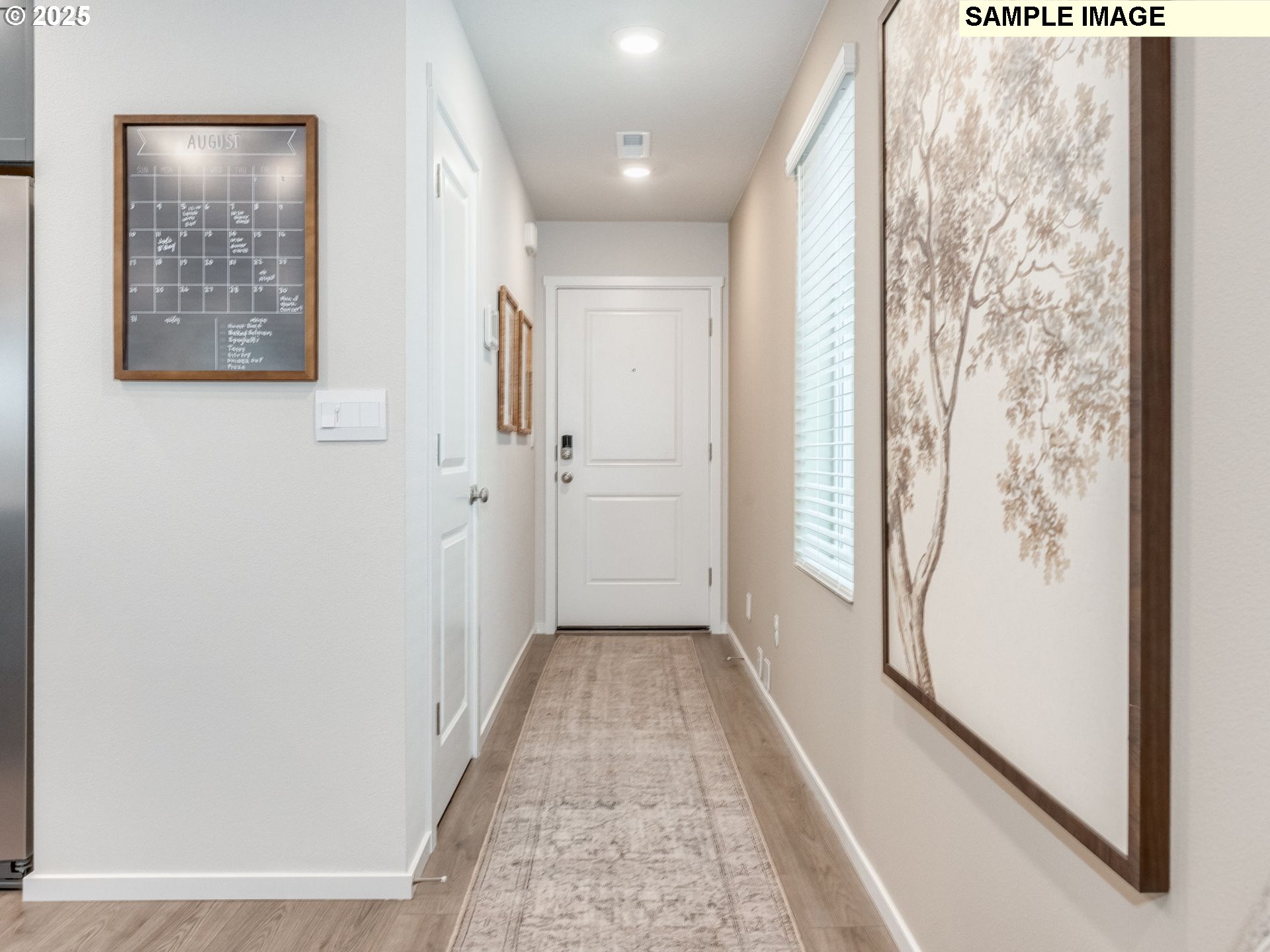1113 Southeast 194th Place Camas, WA 98607 - Photo 2 of 27 a view of a hallway with wooden floor and a bathroom