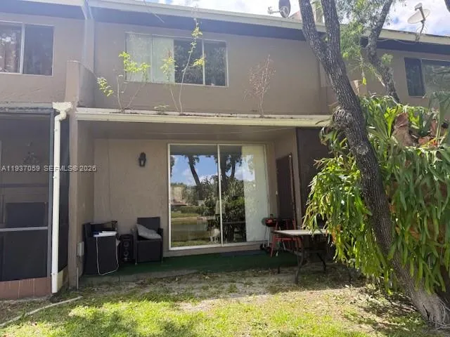 a view of a house with a yard and sitting area