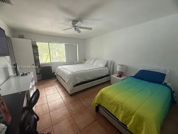 a bedroom with two beds and a dresser