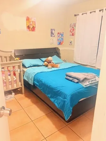 a bedroom with a bed and a wall painting