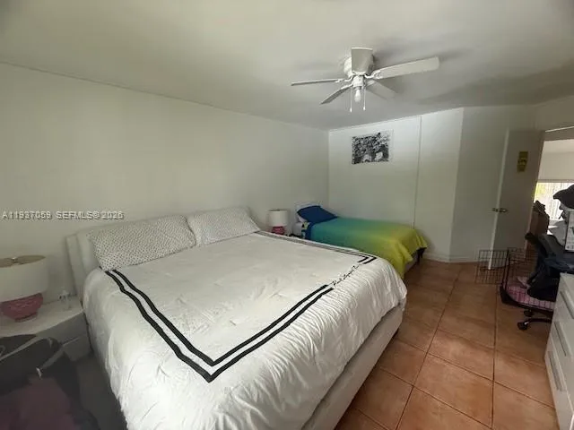 a bed sitting in a bedroom next to a bathroom