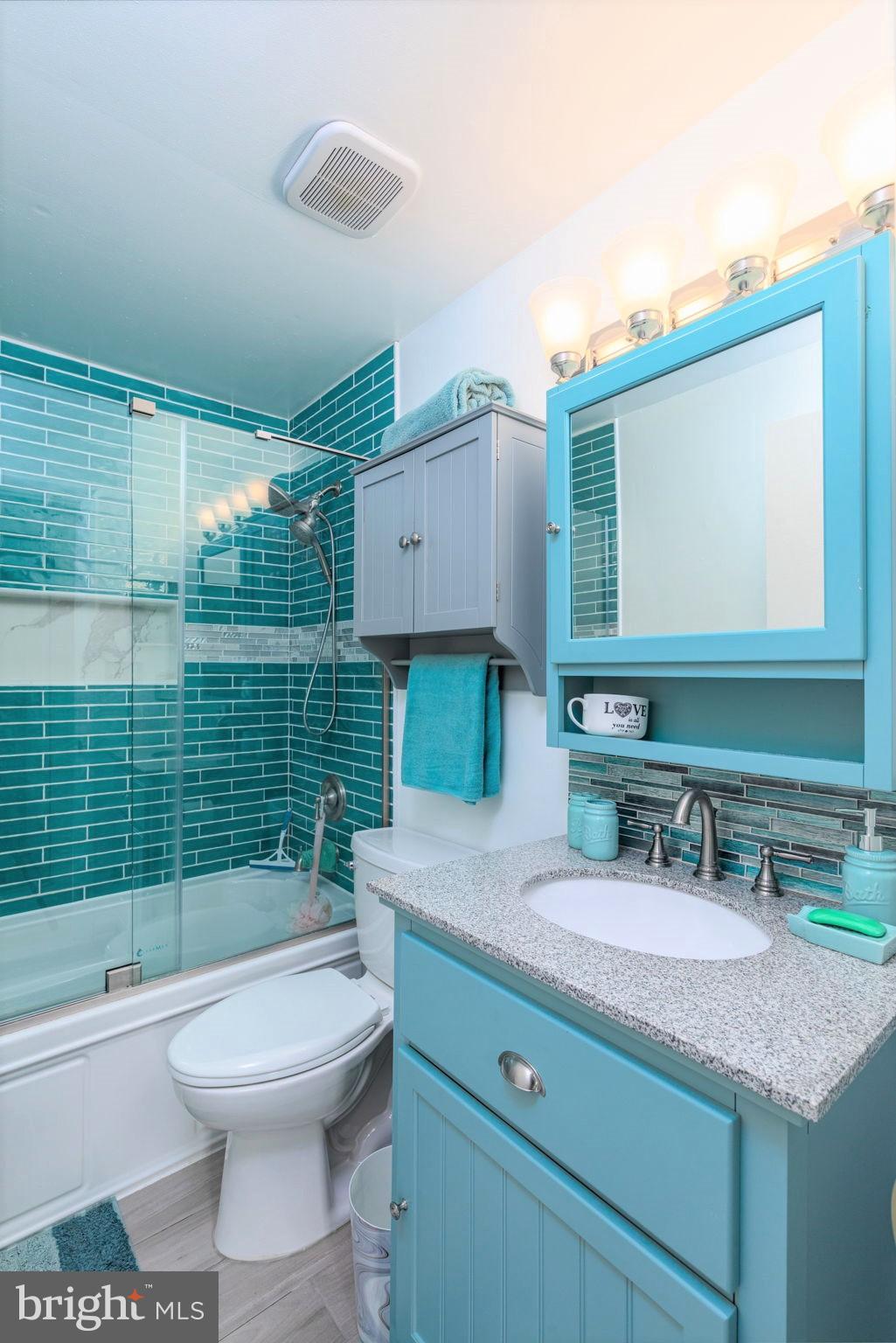 9021 Moonstone Road Nottingham, MD 21236 - Photo 22 of 36 a bathroom with a granite countertop toilet sink and mirror