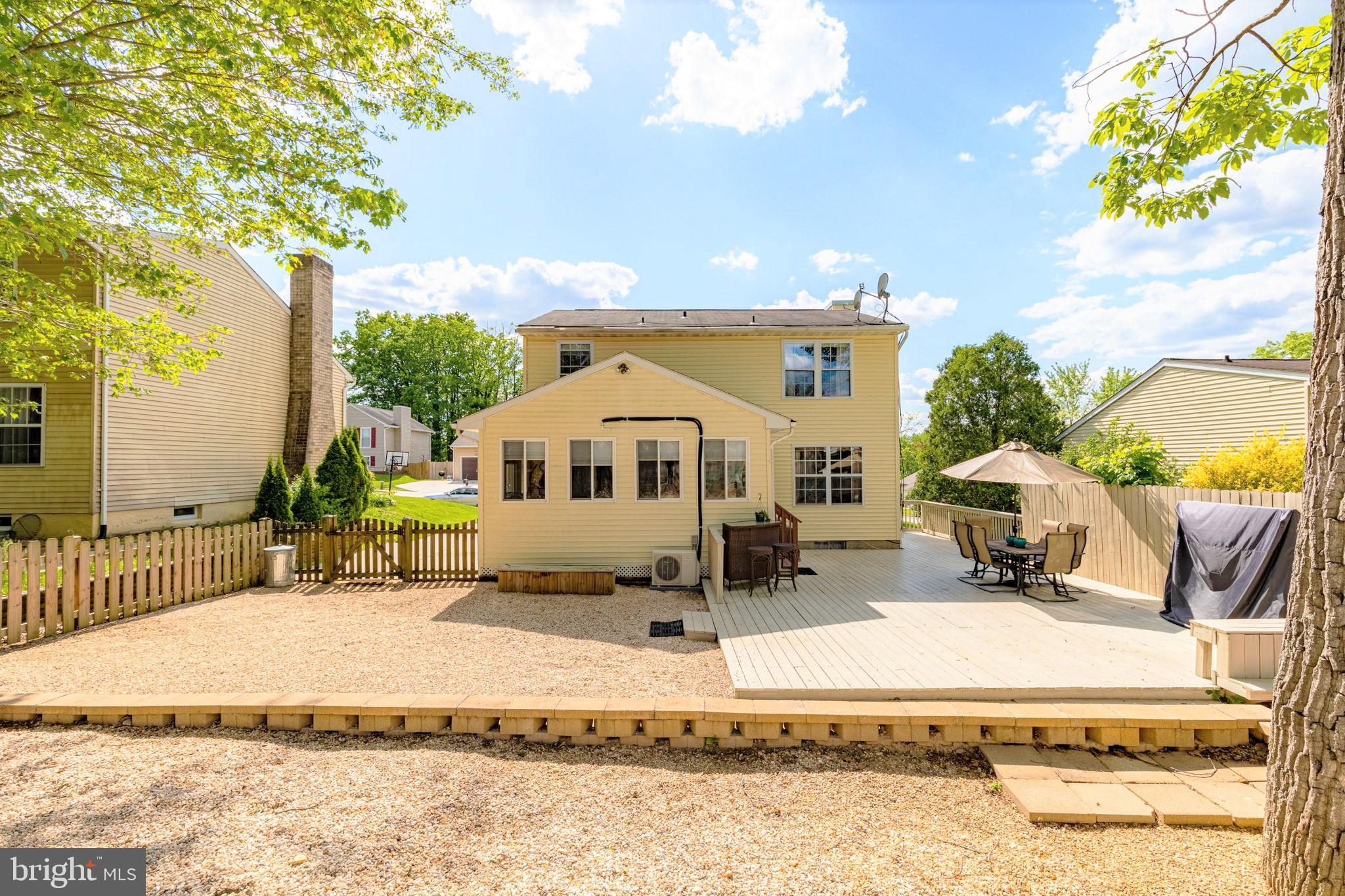 9021 Moonstone Road Nottingham, MD 21236 - Photo 36 of 36 a roof deck with table and chairs under an umbrella