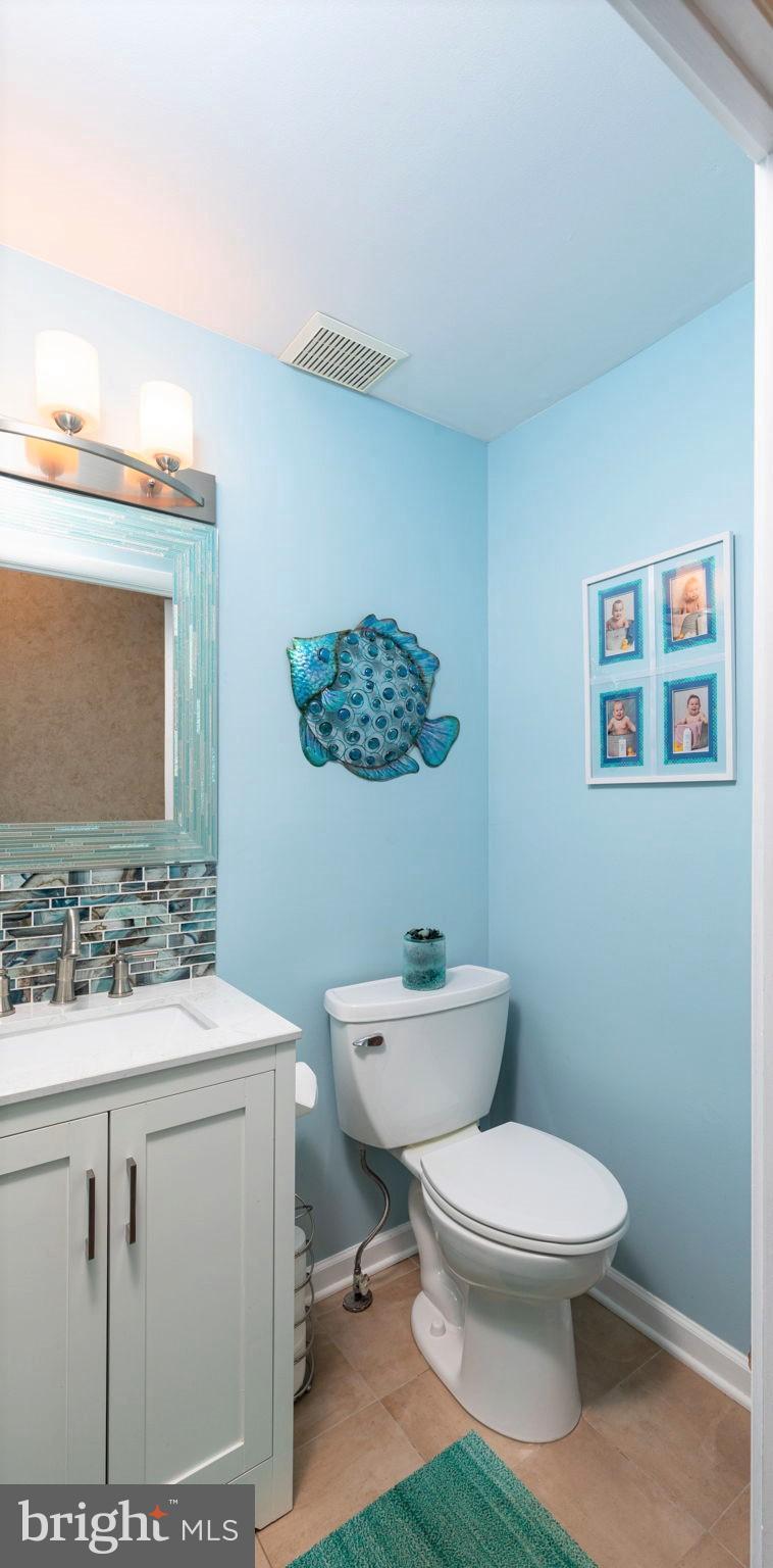 9021 Moonstone Road Nottingham, MD 21236 - Photo 8 of 36 a bathroom with a toilet a sink and mirror