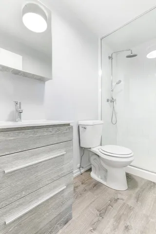 a bathroom with a toilet and a shower