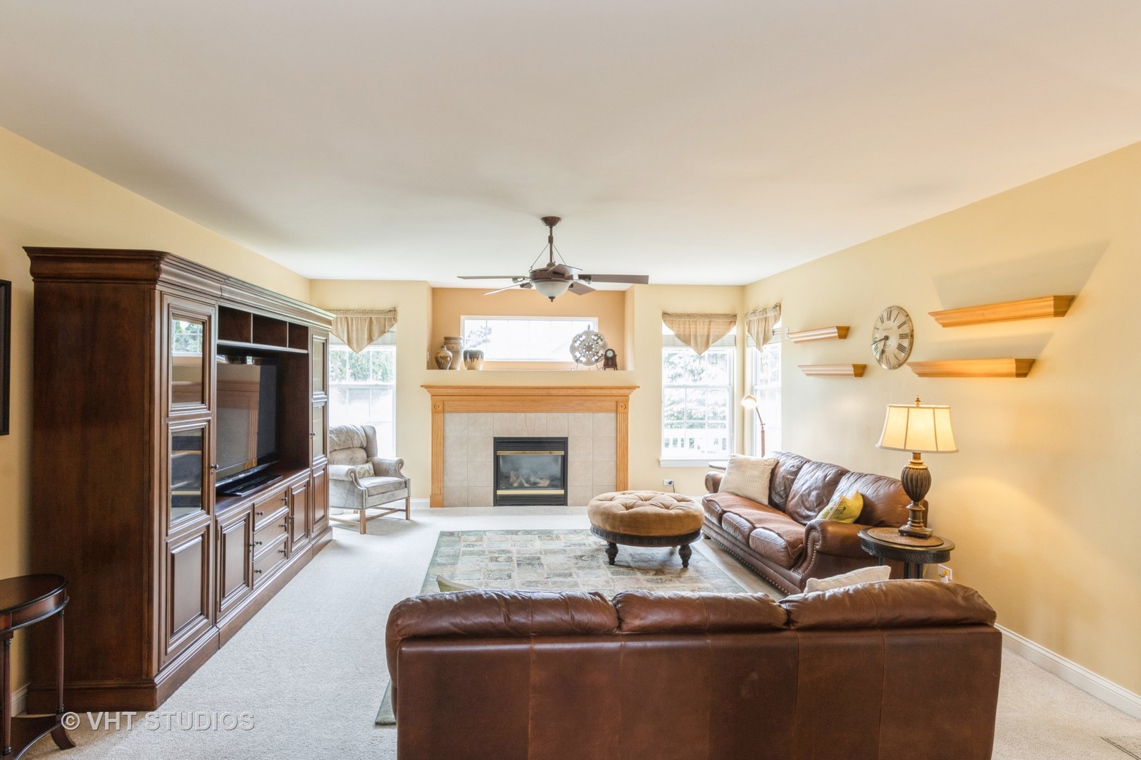 210 Bridle Path Lane Fox River Grove, IL 60021 - Photo 6 of 17 a living room with furniture a flat screen tv and a fireplace